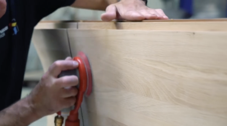 Sanding the solid-wood counter front in the Hoffmann Interior workshop