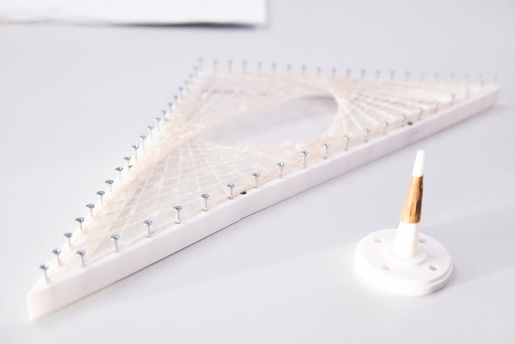 String-art model on a triangular 3D-printed frame
