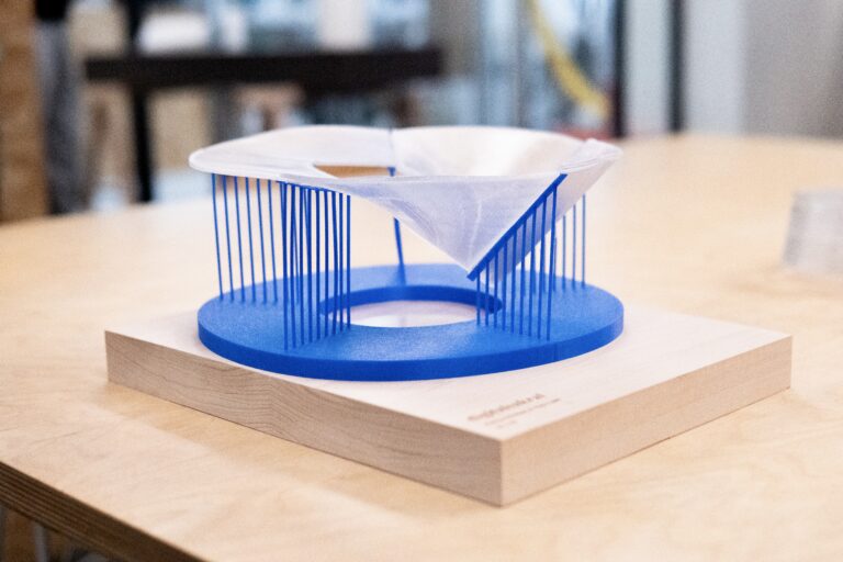 3D-printed model of the funnel-shaped pavilion with blue columns
