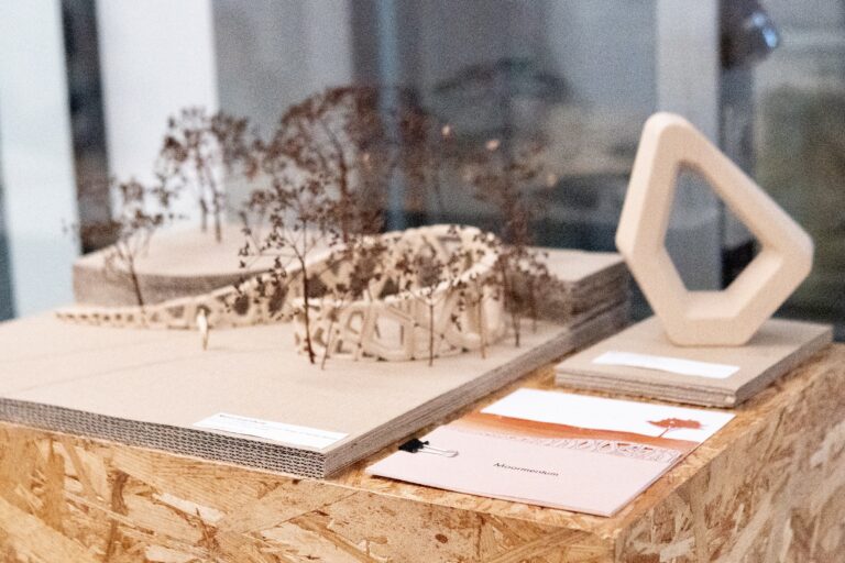 Landscape model with trees and a wooden ring sculpture
