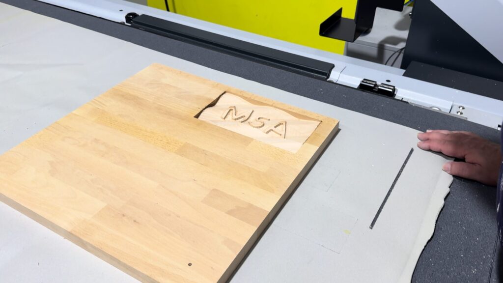 Finished 3D-milled relief with MSA lettering on a wooden board