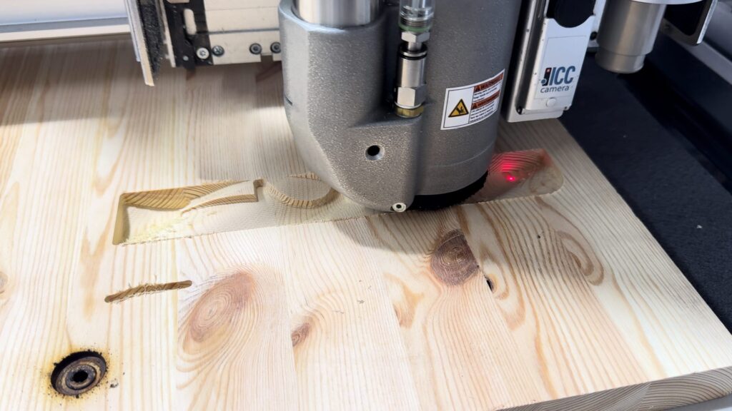 Zünd router milling a freeform relief surface into a wooden board